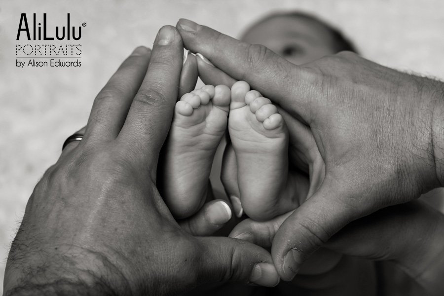 baby's feet in mum and dad/s hands